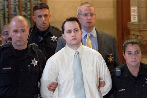 Police surround Richard Poplawski as he is led from court after a jury sentenced him to death.