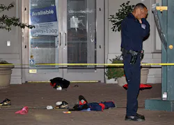 An Oakland police officer raises his hands to his head at the scene where a man was shot and killed near an Occupy Oakland encampment Thursday, Nov. 10, 2011, in Oakland, Calif. An Oakland police officer raises his hands to his head at the scene where a man was shot and killed near an Occupy Oakland encampment Thursday, Nov. 10, 2011, in Oakland, Calif.