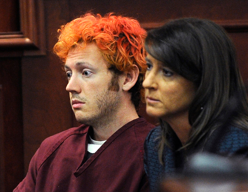 In this Monday, July 23, 2012 file photo, James Holmes, accused of killing 12 people in Friday's shooting rampage in an Aurora, Colo., movie theater, appears in Arapahoe County District Court with defense attorney Tamara Brady in Centennial, Colo. With their anger and tears stirred by the sight of Holmes in a courtroom with red hair and glassy eyes, the families of those killed in the Colorado theater massacre now must go home to plan their final goodbyes.