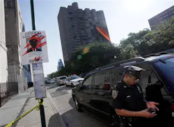 A New York City police officer guards the crime scene perimeter on New York's Lower East Side, Thursday, July 5, 2012, where a New York City police officer was shot in the building, background center.Police say the officer was hit in his bullet-proof vest Thursday morning on Essex Street. He was taken to Bellevue Hospital where he was listed in stable condition. A New York City police officer guards the crime scene perimeter on New York's Lower East Side, Thursday, July 5, 2012, where a New York City police officer was shot in the building, background center.Police say the officer was hit in his bullet-proof vest Thursday morning on Essex Street. He was taken to Bellevue Hospital where he was listed in stable condition.