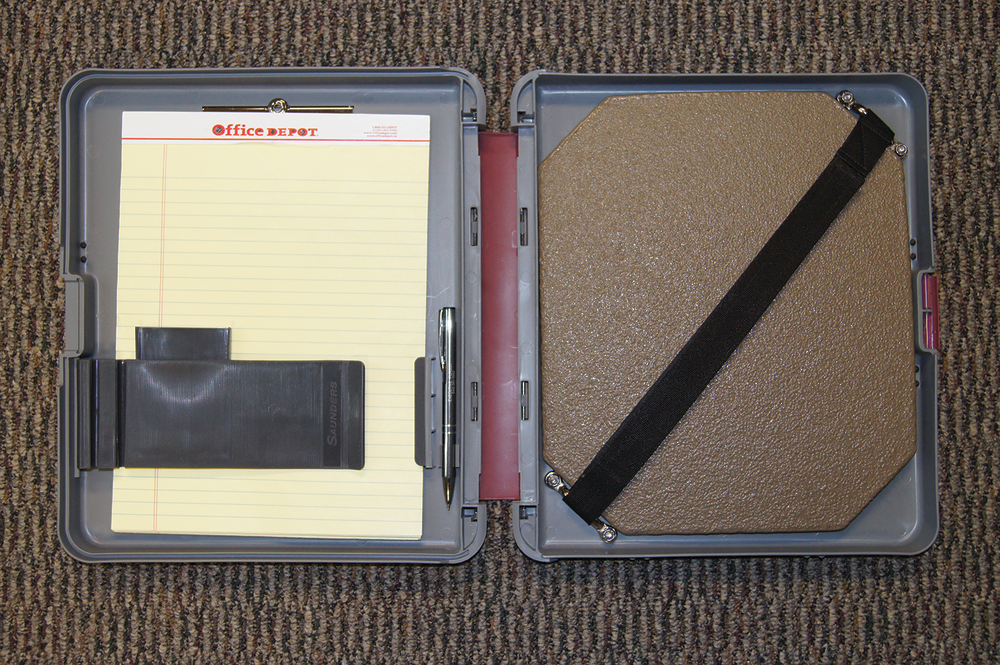A storage notebook that holds paper, pen and the IIIA plate that could be used for protection during a traffic stop. Open.