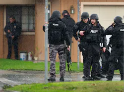 Sacramento Police SWAT team members gather near a crime scene where a Sacramento Animal Control officer was fatally shot through the door of a residence in Galt, Calif. on Nov. 28. Sacramento Police SWAT team members gather near a crime scene where a Sacramento Animal Control officer was fatally shot through the door of a residence in Galt, Calif. on Nov. 28.