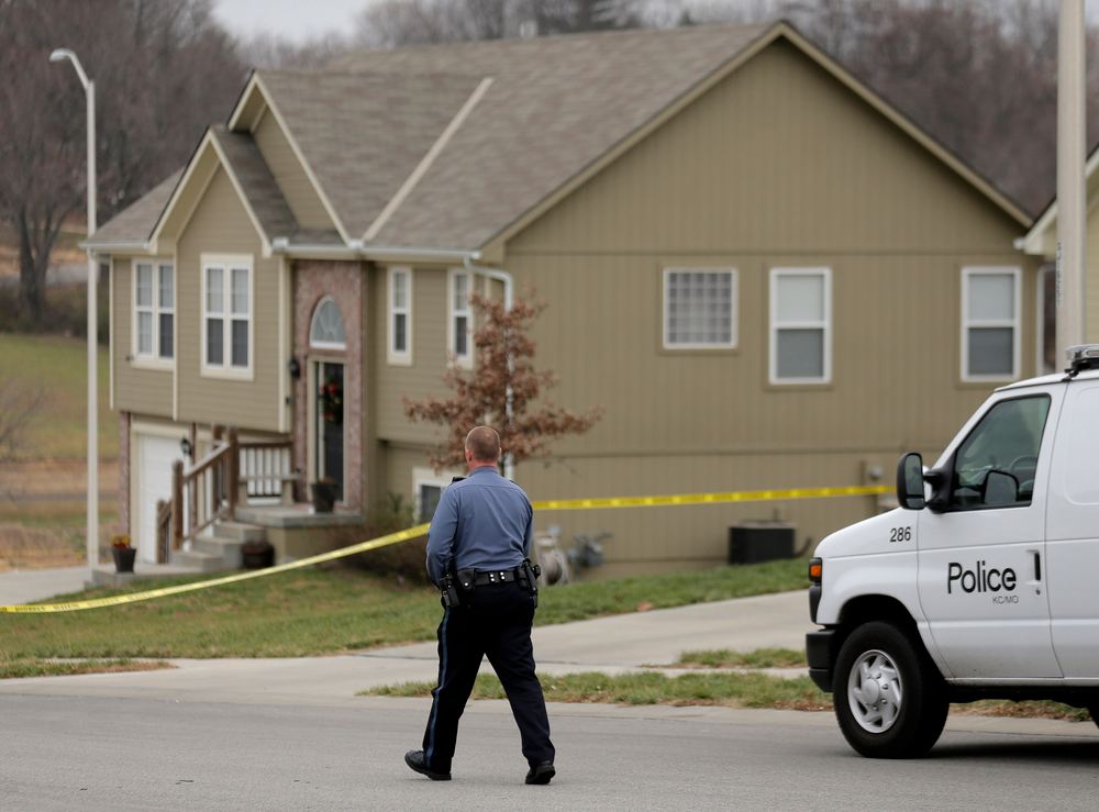 A police officer walks to an Independence, Mo., house house where police say Kansas City Chiefs linebacker Jovan Belcher fatally shot his girlfriend before driving to the NFL football team''s training facility and shooting himself.