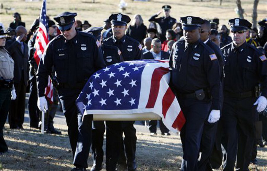 Officers carry the casket containing the remains of Memphis Police Officer Martoiya Lang at Southwoods Memorial Park on Dec. 21.
