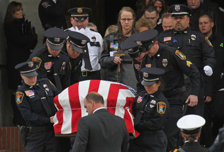 The casket of Cold Spring-Richmond Officer Thomas Decker is carried from St. John's Abbey and University Church at St. John's University in Collegeville, Minn. on Dec. 5.
