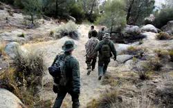 Wardens with the California Department of Fish and Game detain a pair of men during a raid on an illegal marijuana growing operation in the Sierra Nevada foothills. Wardens with the California Department of Fish and Game detain a pair of men during a raid on an illegal marijuana growing operation in the Sierra Nevada foothills.