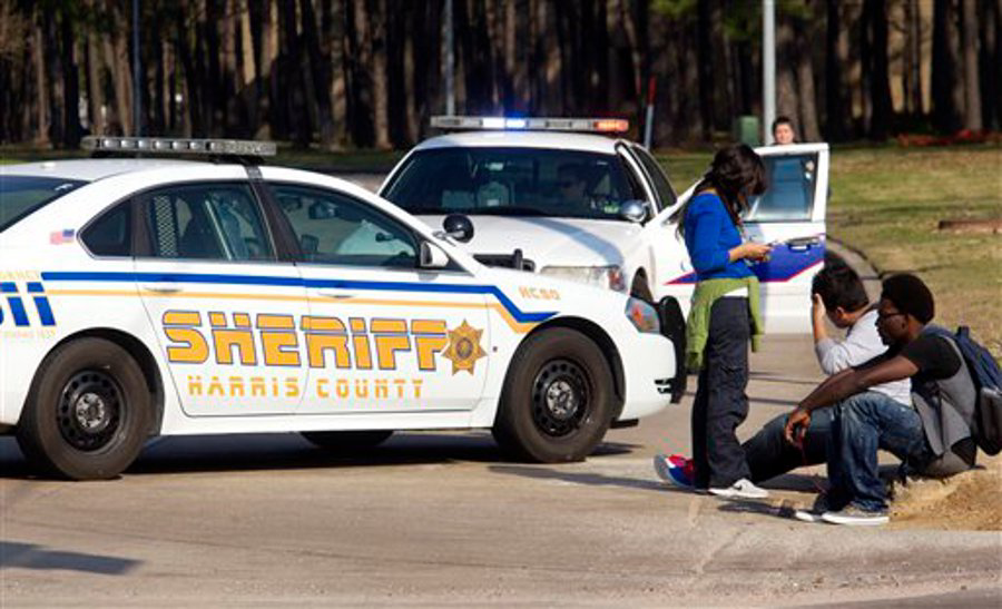 Students wait outside an entrance to the Lone Star College North Harris campus after a shooting on campus in Houston on Jan. 22.