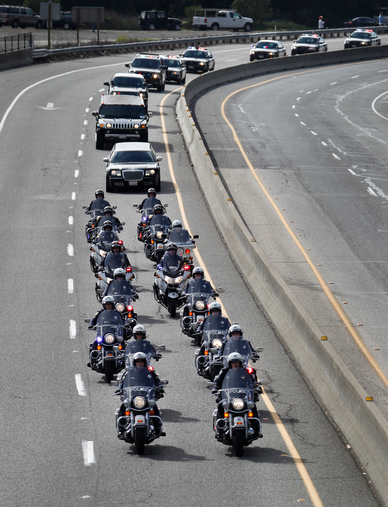 A procession of police officers from supporting agencies, coming from Santa Cruz heads north on Hwy 17 near Bear Creek Road on their way to HP Pavilion in San Jose, Calif. on March 7.