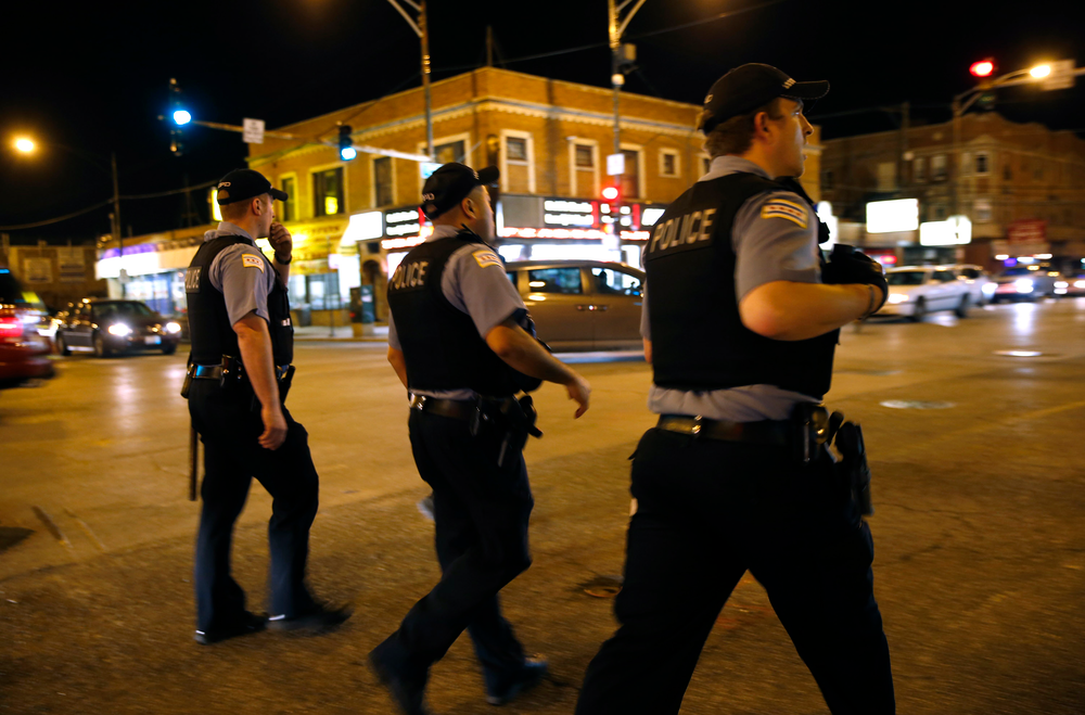 Chicago police officers walk along Cottage Green Avenue during foot patrol on April 30.