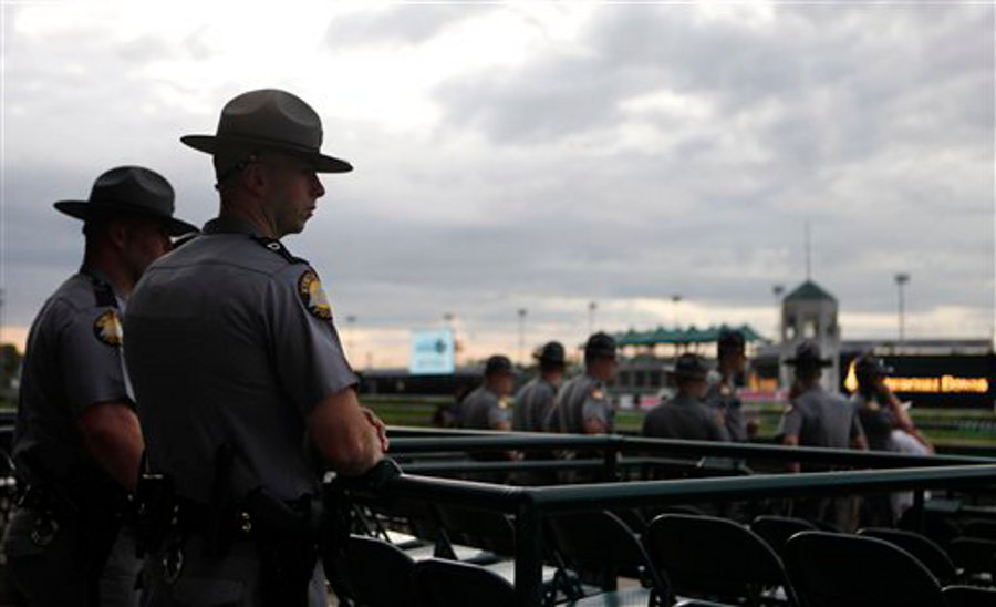Kentucky State Police watch the race track during morning workouts at Churchill Downs on May 3 in Louisville, Ky.
