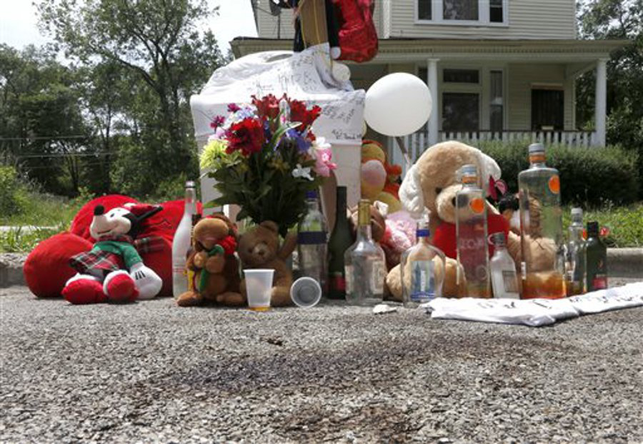 Blood stains and a make shift memorial for 18-year-old Jamal Jones is seen where police found him with gunshots wounds to the shoulder and chest over the past weekend, on Chicago's Southside on June 17.