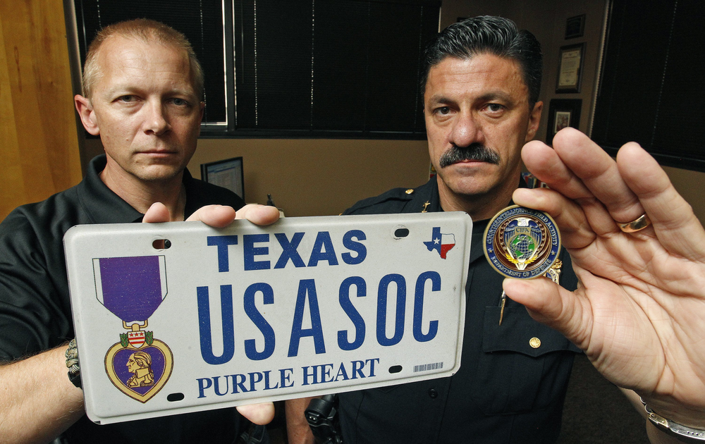 Special Investigations Unit lead investigator Brad Thompson, left, and Fort Worth Police Chief Jeff Halstead are seen with evidence items.