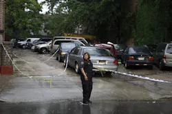 An NYPD police officer holds crime scene tape near a crime scene where three people were shot over the weekend in Brooklyn on June 3. An NYPD police officer holds crime scene tape near a crime scene where three people were shot over the weekend in Brooklyn on June 3.