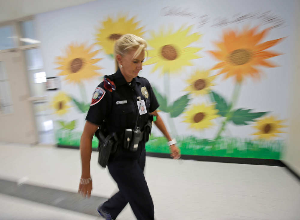 Dara Van Antwerp, the school resource officer at Panther Run Elementary School Pembroke Pines, Fla. walks the hallways of the school on Aug. 22.