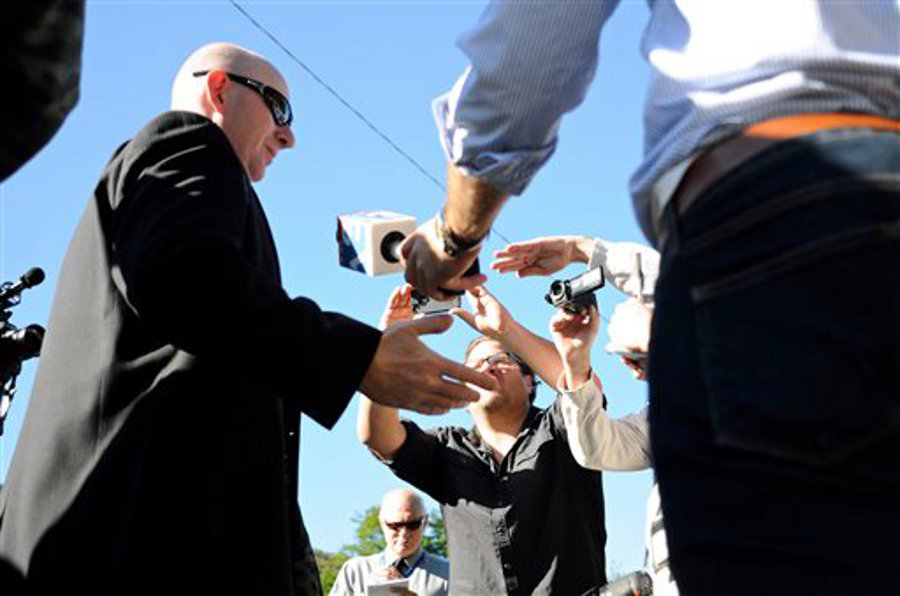 Gilberton Police Chief Mark Kessler, center, talks with the media before a closed disciplinary hearing in the borough building on Sept. 19 in Mahanoy Plane, Pa.