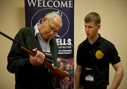 : Legendary custom gunmaker Jerry Fisher examines a student's work at GCCF 2013. : Legendary custom gunmaker Jerry Fisher examines a student's work at GCCF 2013.