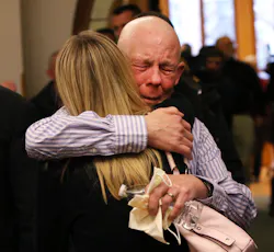 Paul Butterfield, the father of slain Michigan State Police Trooper Paul Butterfield II, embraces his son's fiance Jennifer Sielski after guilty verdicts were read against Eric Knysz on Feb. 25. Paul Butterfield, the father of slain Michigan State Police Trooper Paul Butterfield II, embraces his son's fiance Jennifer Sielski after guilty verdicts were read against Eric Knysz on Feb. 25.