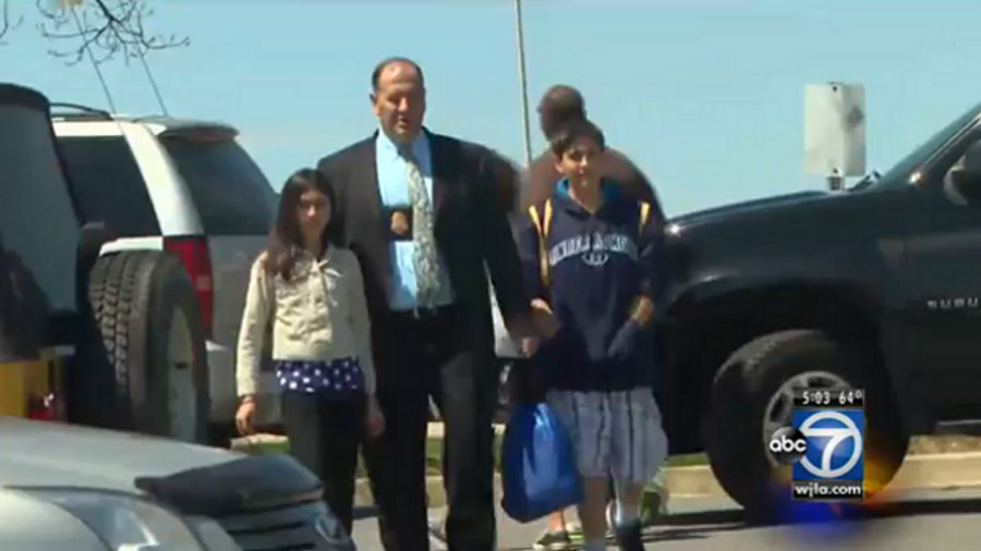 A Montgomery County, Md. Police detective who had his children with him as part of 'Take Your Kids to Work Day' rescued a woman from a fatal house fire Thursday.