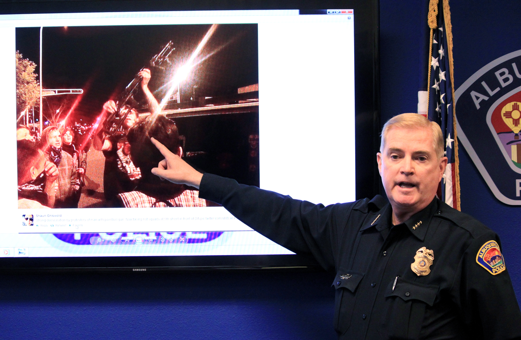 Albuquerque Police Chief Gorden Eden shows the image of a man who brought a rifle to an hours' long protest over police shootings during a news conference on March 31.
