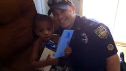 Officer Derek Pratico is seen with the young boy. Officer Derek Pratico is seen with the young boy.