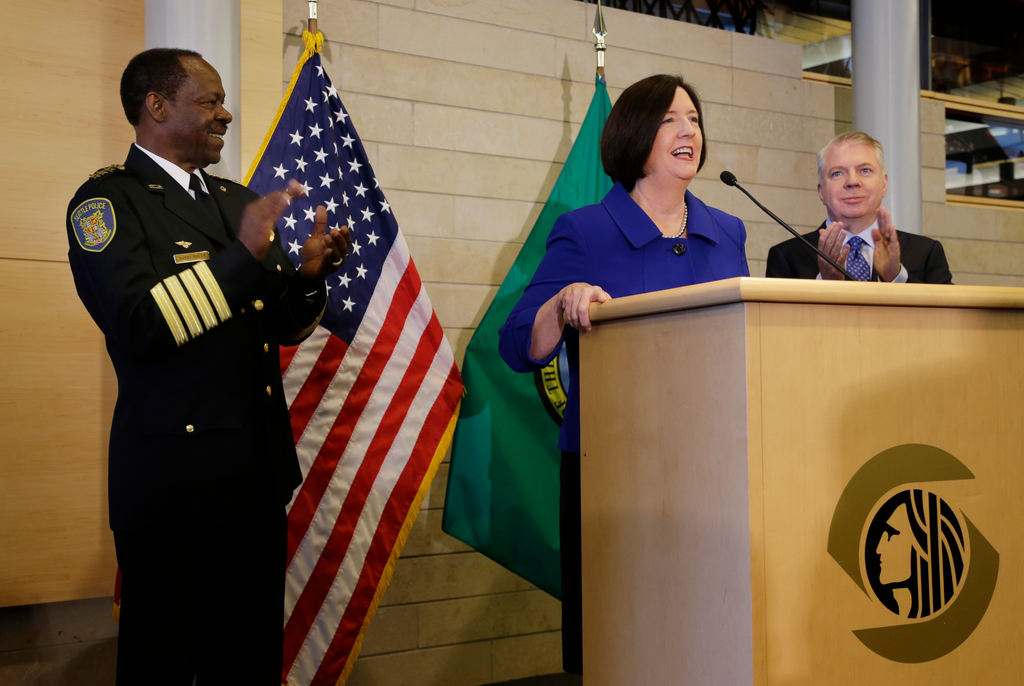 Former Boston police commissioner Kathleen O'Toole center, speaks after being introduced by Seattle Mayor Ed Murray, right, as his nominee to be Seattle's new Chief of Police on May 19.