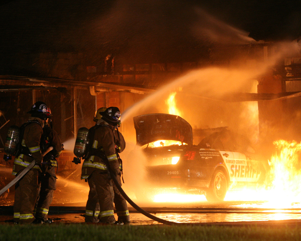 A Ramsey County sheriff's squad car spun out on a curve during a Thursday night pursuit and crashed into a commercial building in Vadnais Heights, hitting a natural gas line and sparking a fire.