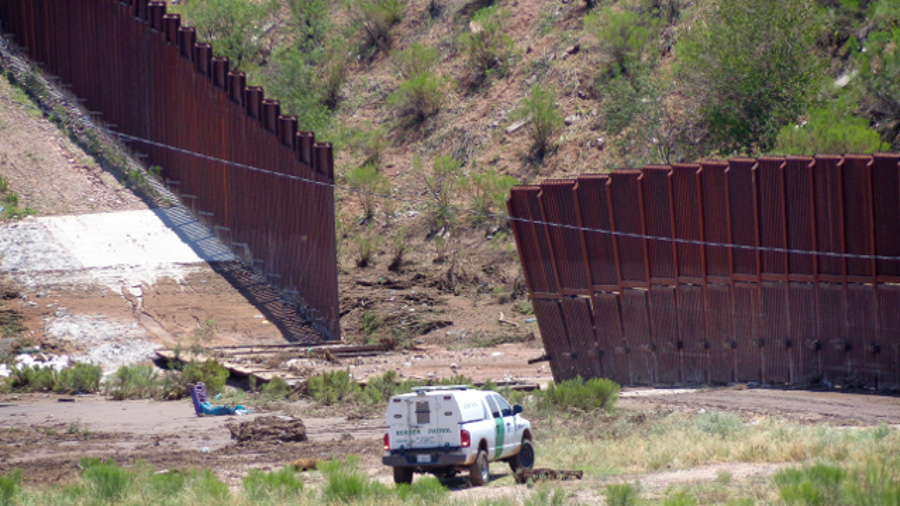A border patrol vehicle stands guard at a section of collapsed fence just west of the Mariposa Port of Entry in Nogales, Ariz. on July 27.