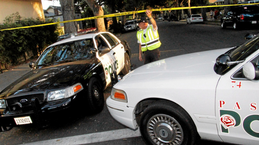 Pasadena police officers block off a street corner following a shooting in residential Pasadena neighborhood, in Pasadena, Calif. on July 12.