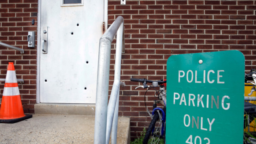 Bullet holes are seen in a door at police headquarters on Aug. 12 in West Deptford, N.J.