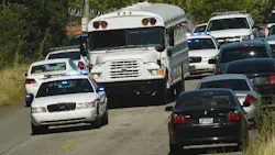 Police officers escort UPS employees on a bus from the scene where three people were killed, including the gunman, at a UPS facility in Birmingham, Ala. on Sept. 23. Police officers escort UPS employees on a bus from the scene where three people were killed, including the gunman, at a UPS facility in Birmingham, Ala. on Sept. 23.