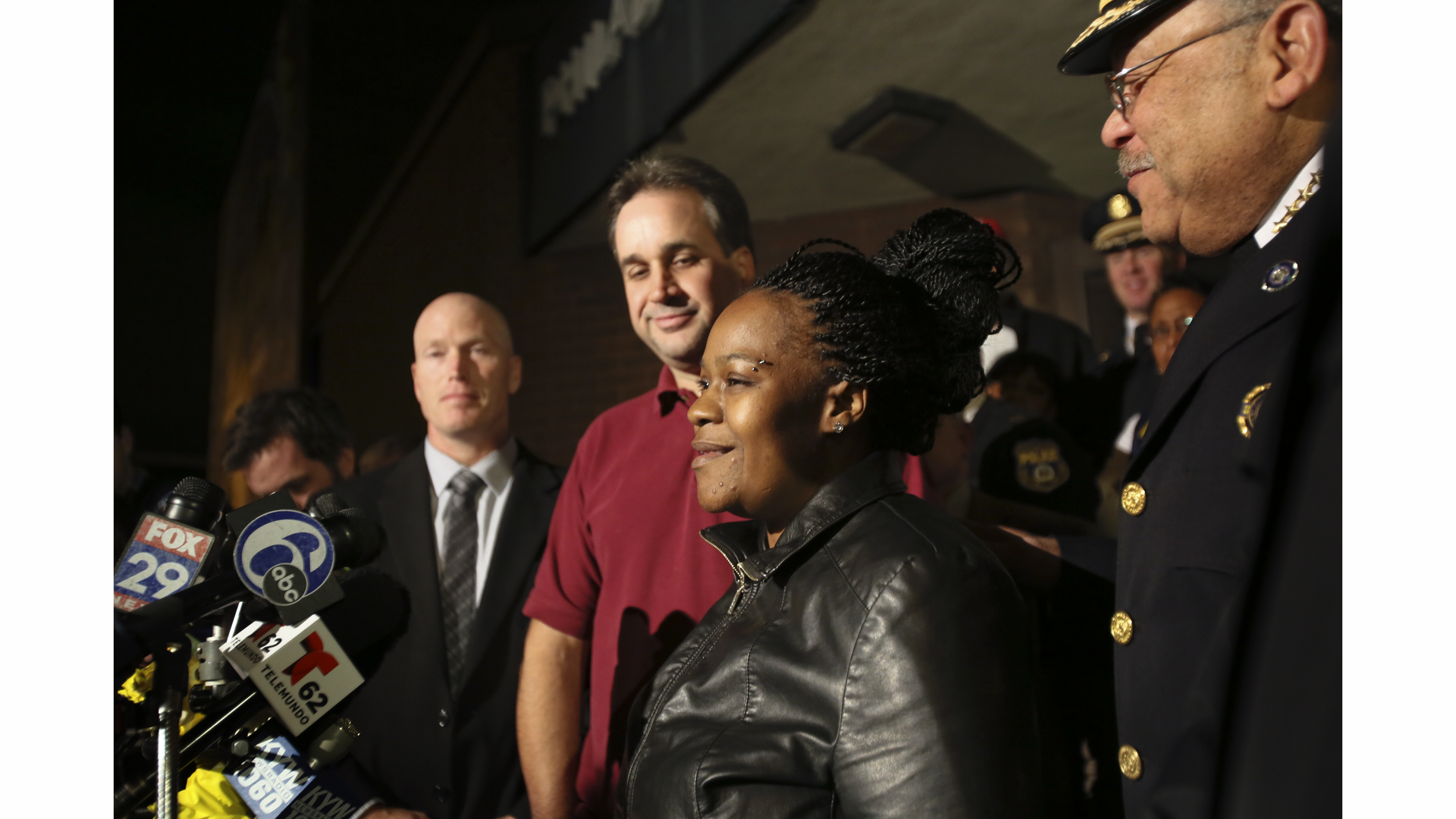 Police officials surround Keisha Gaither, second from right, mother of kidnapping victim Carlesha Freeland-Gaither, following a news conference in Philadelphia on Nov. 5.