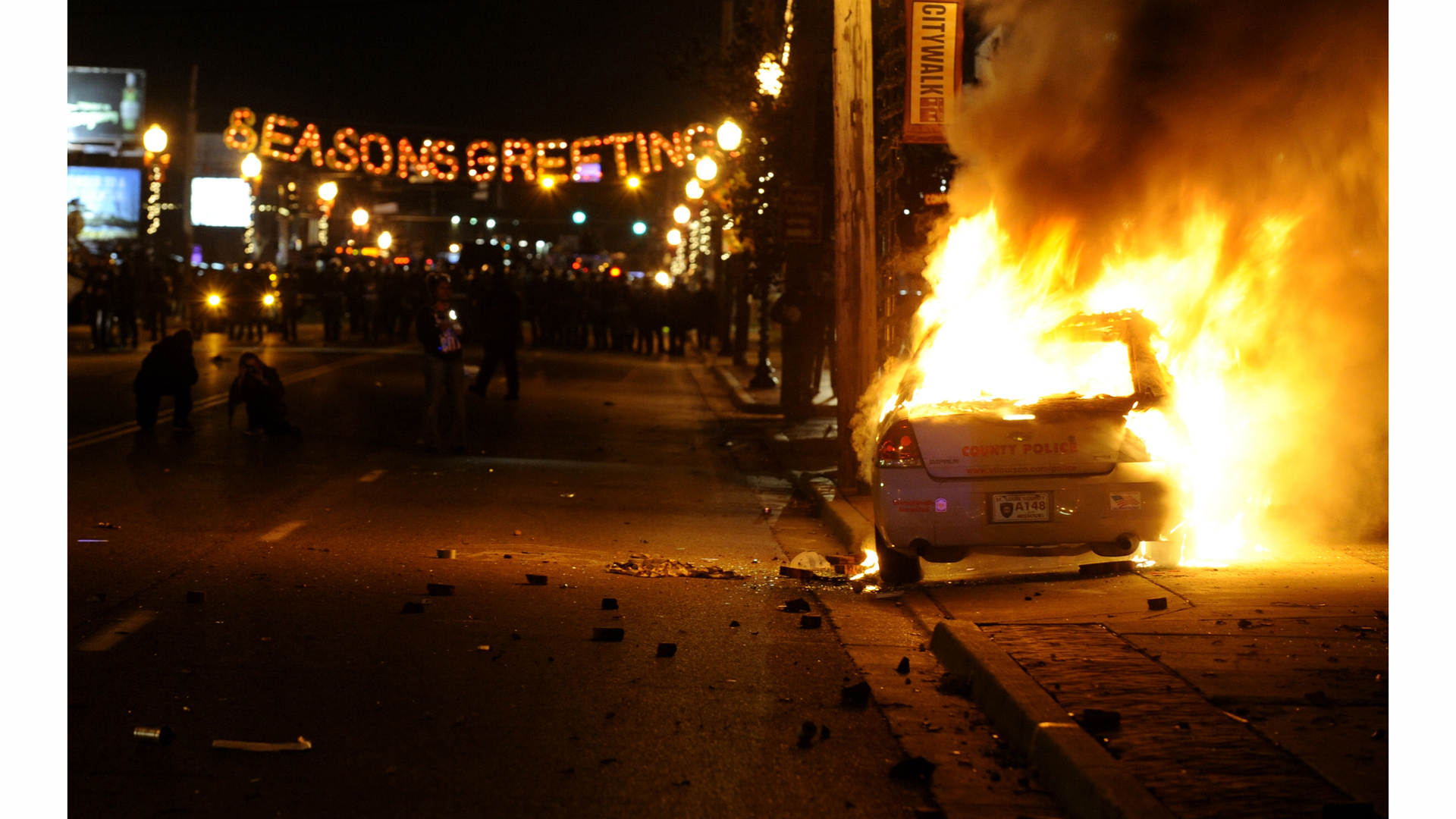 A St. Louis County police car is set on fire along South Florissant Road in Ferguson following the announcement of the grand jury decision on Nov. 24.
