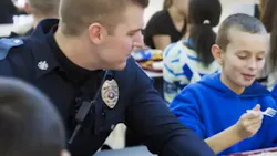 Officer Corey Sheaffer joined a boy at his school for lunch after a bet on the basketball court. Officer Corey Sheaffer joined a boy at his school for lunch after a bet on the basketball court.