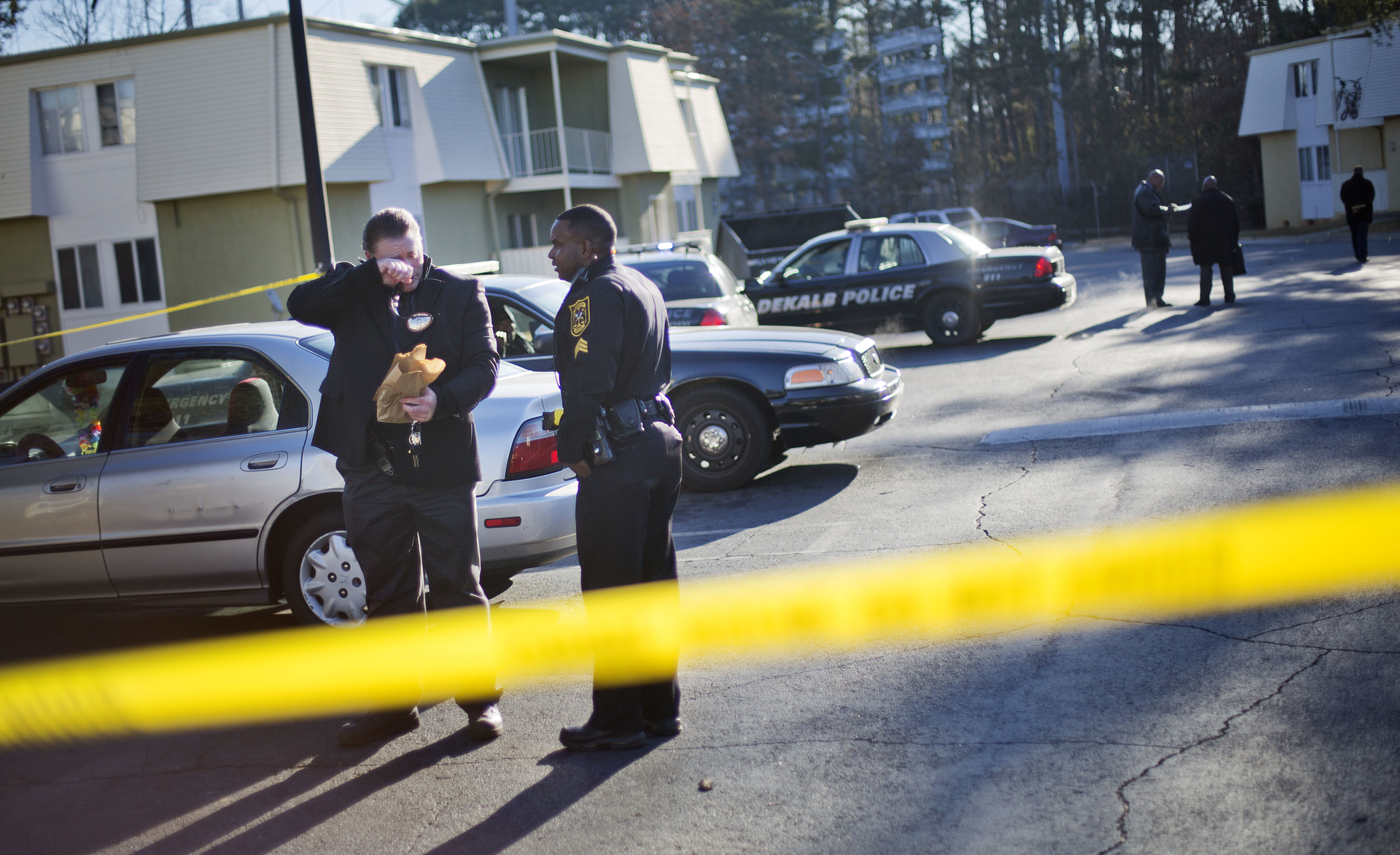 gaofficershot 548b238b1bc5c Police investigate the scene of an apartment complex where authorities say two officers were shot leading to a neighborhood search for the suspected gunman on Dec. 12.