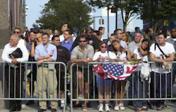 People are seen standing near Ground Zero in New York City on Sept. 11, 2002 to honor the victims lost one year earlier in the 9/11 terrorist attacks. People are seen standing near Ground Zero in New York City on Sept. 11, 2002 to honor the victims lost one year earlier in the 9/11 terrorist attacks.