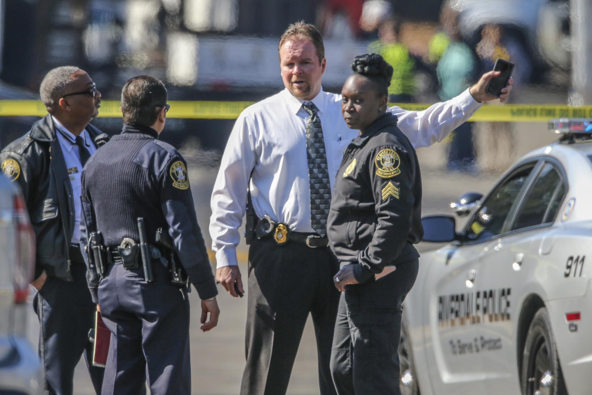Officers converse at the scene of a fatal police shooting during the investigation on Feb. 11 in Riverdale, Georgia.