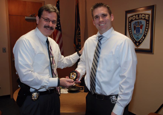 Sayreville police officer Matt Kurtz, pictured at right, receives his new rank of detective at a November ceremony.