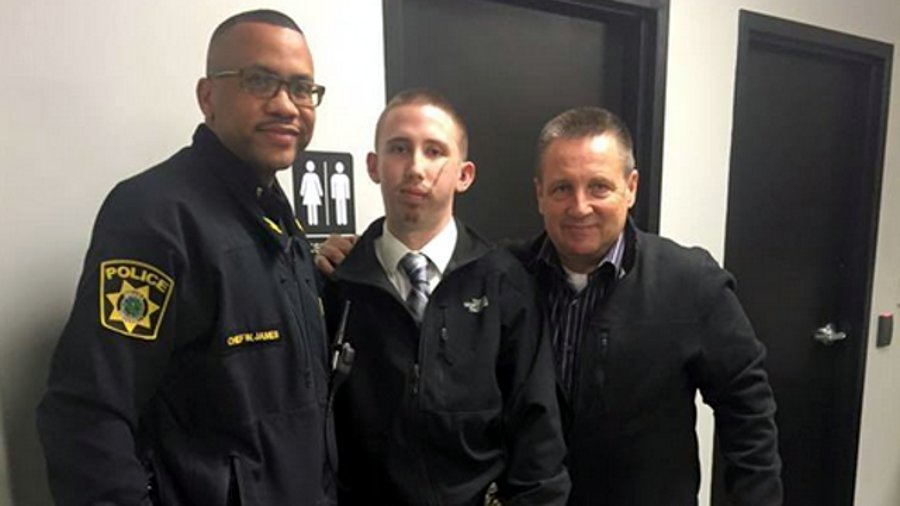 Officer Ed Morrison, center, is seen with Interim Police Chief Wayne James, left, and his uncle, Bob Morrison