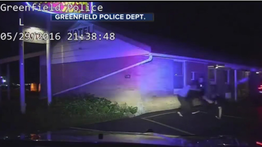 Newly released dashboard camera video shows a suspect attack several Greenfield police officers after a Taser was used on him.