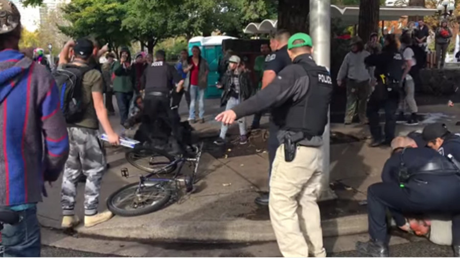 Police officers in Eugene were making a drug arrest in the city's downtown Friday afternoon when they were confronted by an angry mob.