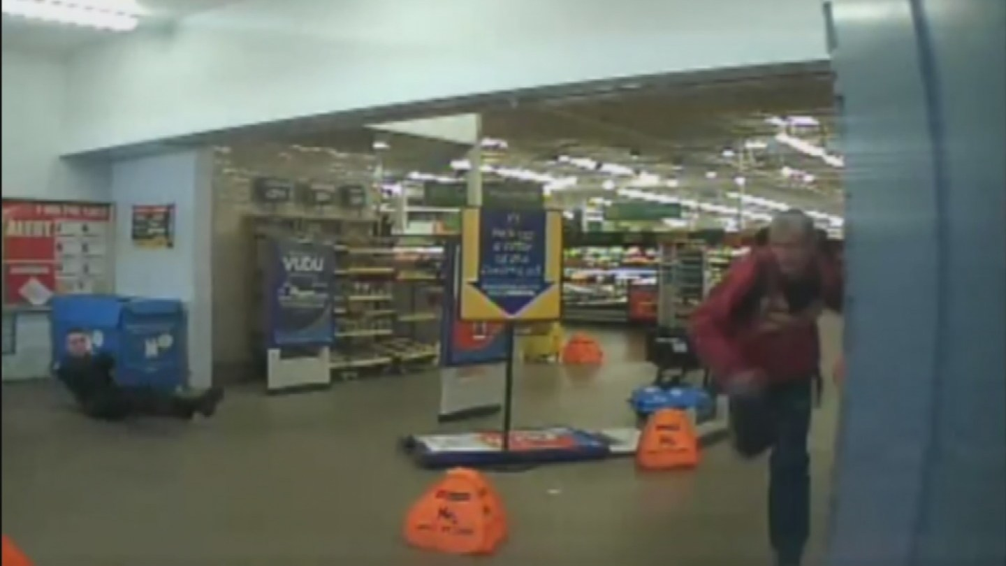 Officer Daniel Colwell tumbled through a display sign and opened fire on the suspect while still on the ground.