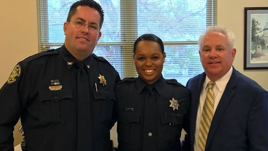 Berkeley County Sheriff's Cpl. Kimber Gist, center, is flanked by Chief Deputy Mike Cochran and Sheriff Duane Lewis on her return to full duty Tuesday.
