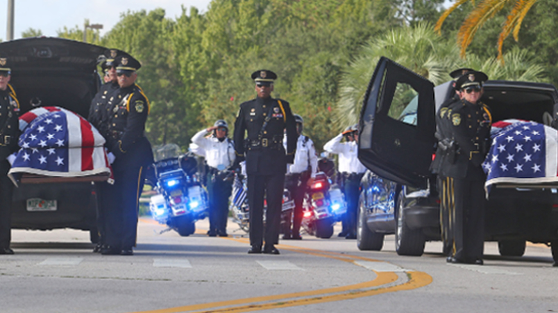 Orlando Police Honor Guard carry the caskets of Kissimmee Police officer Matthew Baxter, left, and Sgt. Sam Howard Thursday, August 24, 2017 for funeral services at the First Baptist Church of Orlando.