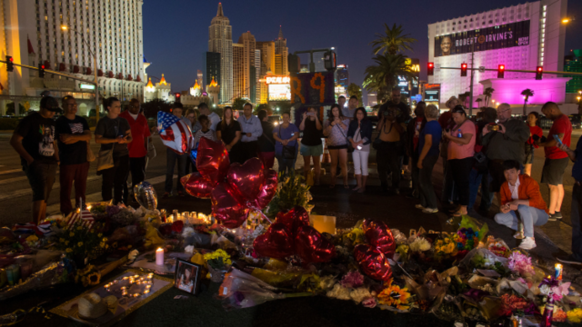A crowd gathers Wednesday, Oct. 4, 2017 to pay tribute at a memorial for the victims of the mass shooting near the crime scene off Las Vegas Boulevard in Las Vegas, Nev.