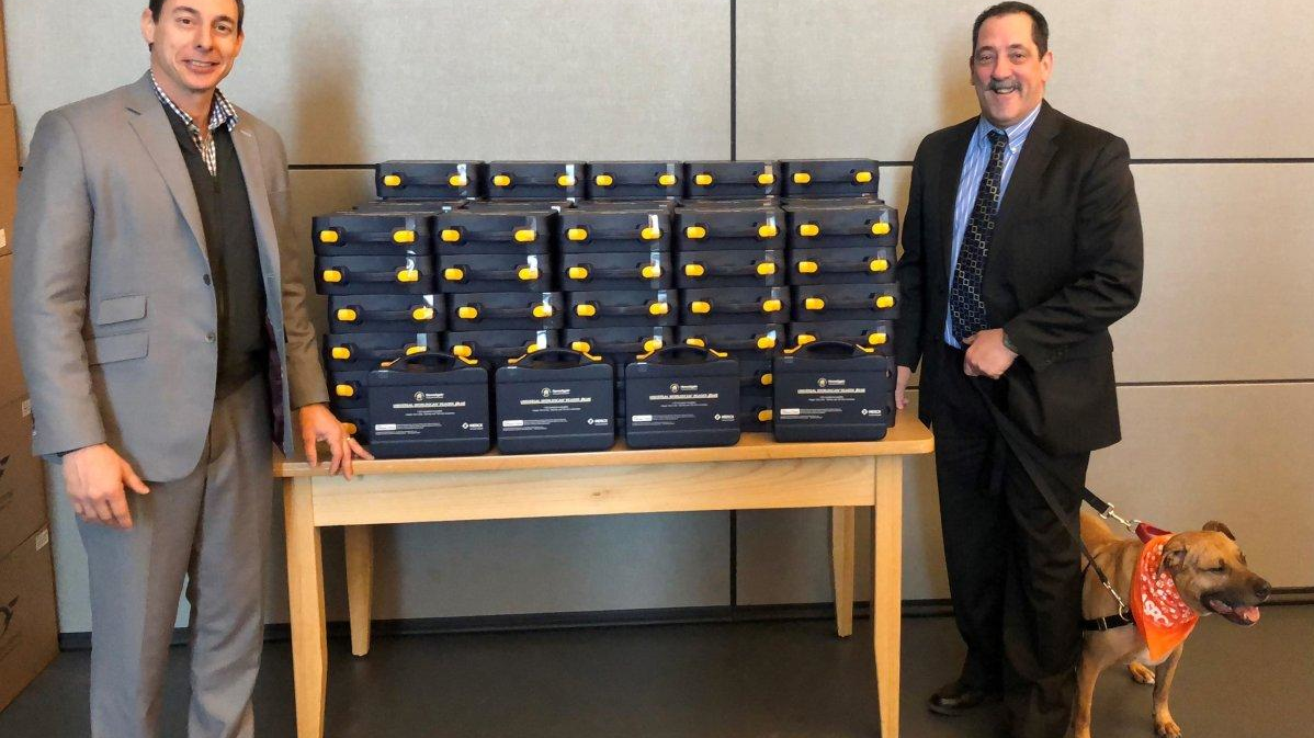 NYPD Captain Mark Gaudioso and Howard Lawrence are seen with the new pet microchip scanners.