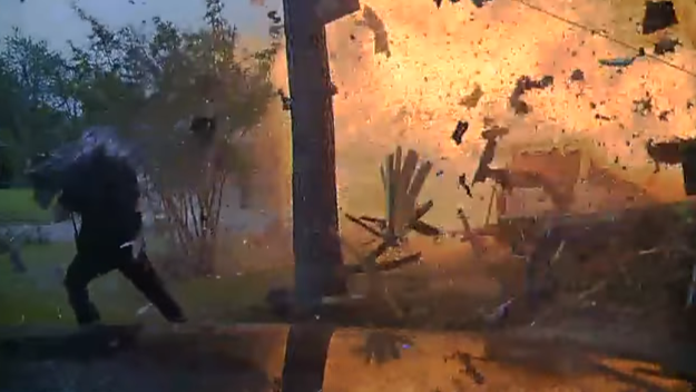 Hurst Police Officer Travis Hiser is shown being blown back, but he recovers and assists police Cpl. Ryan Tooker in getting a couple out of the home.