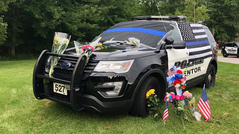Mentor police have a person in custody in connection with an early morning Sunday hit-and-run crash that killed one of its officers.