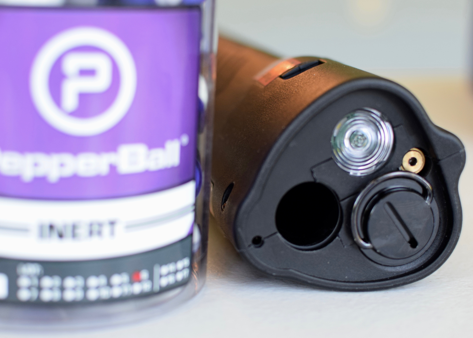 The 350 lm flashlight is right next to the laser emitter, barrel, and CO2 cartridge chamber. The beam of the flashlight is concentric enough to actually guide the PepperBalls. The flashlight is bright enough for general use, although it has a fairly narrow beam and soft spillbeam.