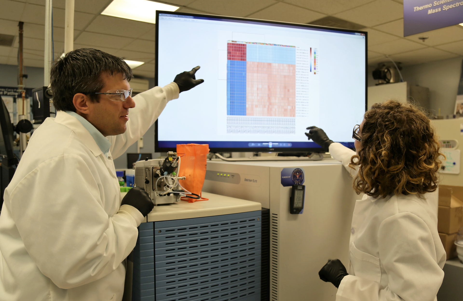 Trevor Glaros, Ph.D., and Elizabeth Dhummakupt, Ph.D., analyze data from a test of biomarkers found in blood to determine opioid exposure.