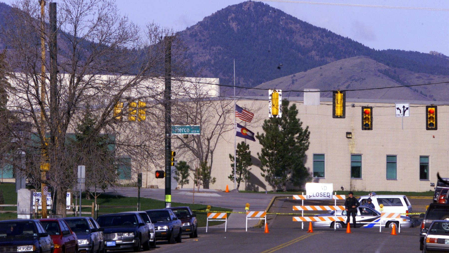 An officer stands guard outside Columbine High School in Littleton, Colorado, one day after the massacre at the suburban Denver school in 1999. Fourteen students and one teacher were killed at the school when two teenage gunmen opened fire on their schoolmates.